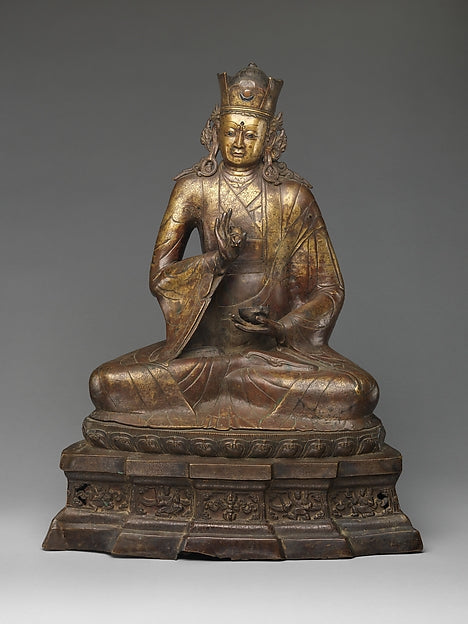Seated copper-alloy figure of Padmasambhava, 14th century, Western Tibet or Ladakh, showing his crown and teaching gesture.