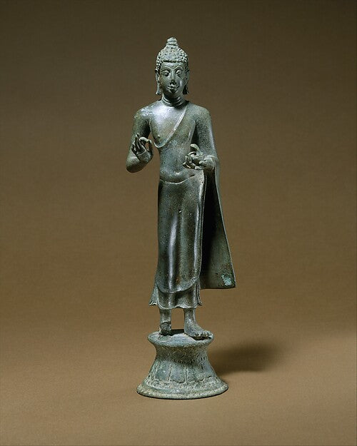 Standing Buddha Shakyamuni, 9th century Java, Indonesia, in bronze with hands raised in teaching gesture, showing Buddhist art across Southeast Asia.