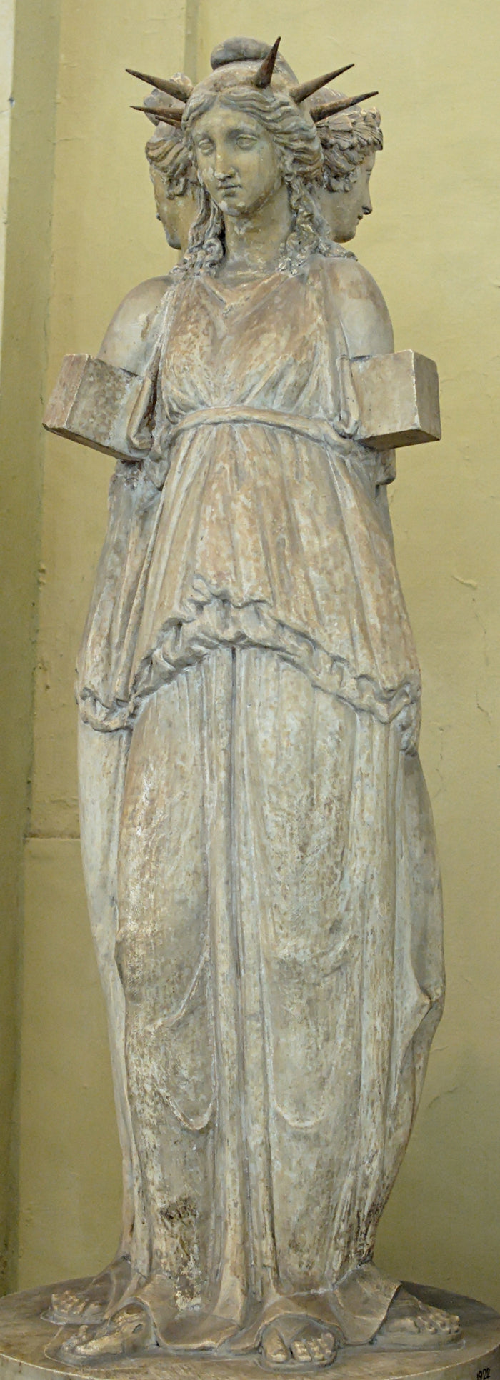 Triple-bodied Hecate statue (Chiaramonti Museum) with a spiked crown, showing her three-formed guardian of crossroads.