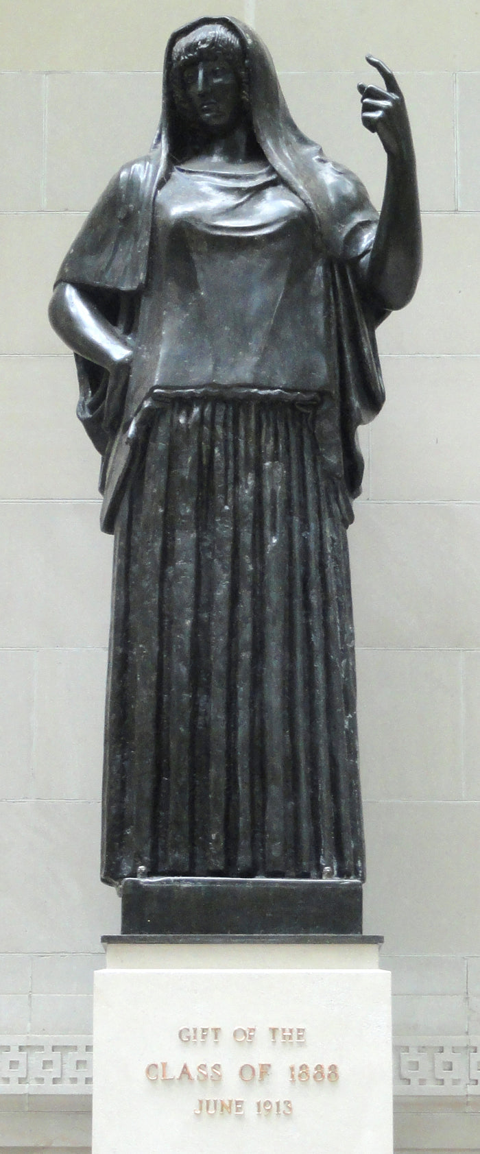 Bronze-toned cast of the Giustiniani Hestia at Wellesley College, showing the veiled head and raised hand of the austere type.