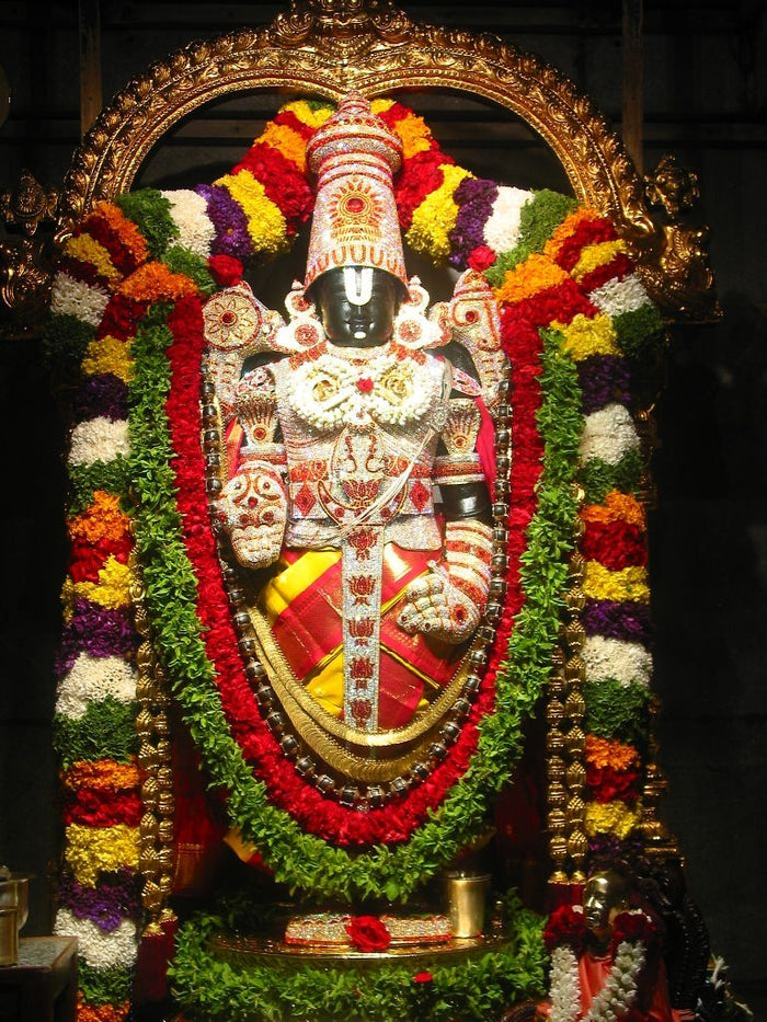 Adorned black stone idol of Venkateswara with tall crown, Vaishnava namam on forehead, and flower garlands, Malekallu Tirupathi-balaji temple, Arsikere.