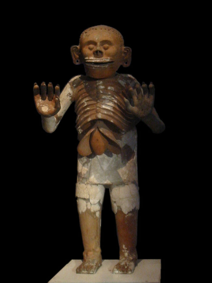 Life-size ceramic Mictlantecuhtli from Templo Mayor: skeletal ribs, exposed liver, raised clawed hands, and a skull-like face.
