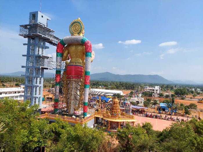 Towering Muthumalai Murugan statue and temple complex with pilgrims, Tamil Nadu, showing living devotion to Murugan.