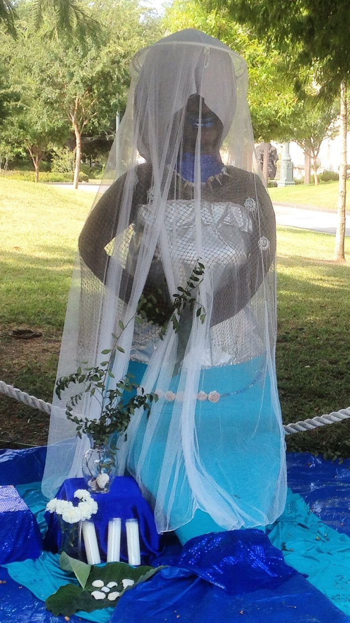 Yemayá altar, 2015, with a white veil, blue and aqua cloth, shells, white flowers and candles, all colours and offerings tied to the sea queen.